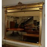A Gilt Overmantel Mirror, in the Victorian style, the plain mirror plate surmounted by a decorate