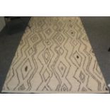 Modernist Moroccan Rug, the cream field with columns of linked diamond medallions, 246cm by 154cm.