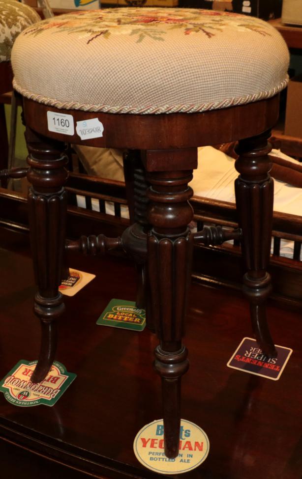 ^ An early 19th century mahogany adjustable piano stool on reeded legs, minimum height 50cm