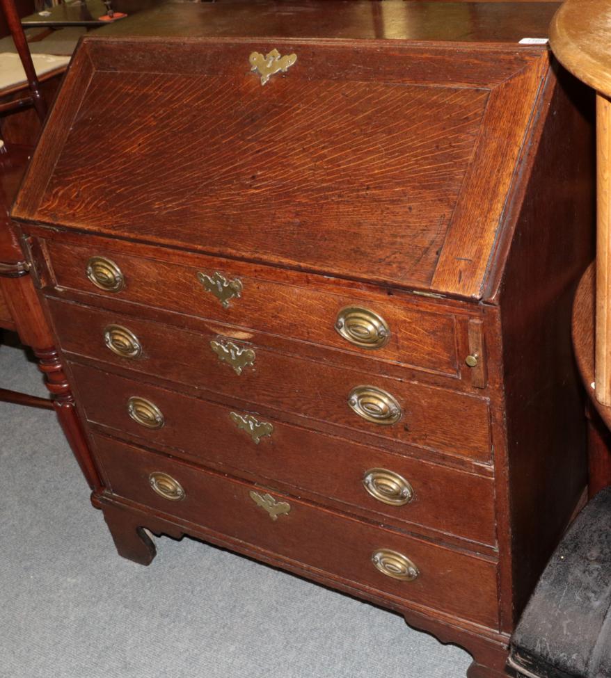 ^ A George III oak bureau with fitted interior, 93cm wide