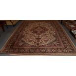 A machine made carpet of Oriental design, cream field with central medallion enclosed by floral