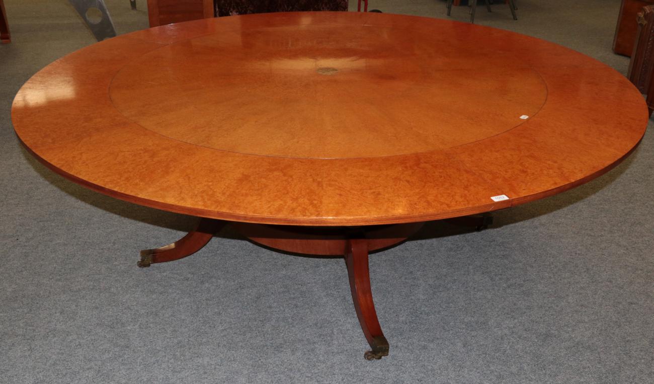 A Reproduction Burr Maple Extending Dining Table, of circular form, with five additional leaves,