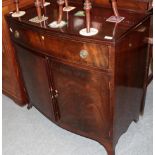 A George II style mahogany bow fronted cabinet with single drawer above two cupboard doors