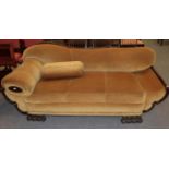 An early 20th century two seater scroll end sofa, upholstered in yellow velvet with carved claw