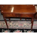 ^ A late George III mahogany fold over tea table on ring turned legs, 91cm wide