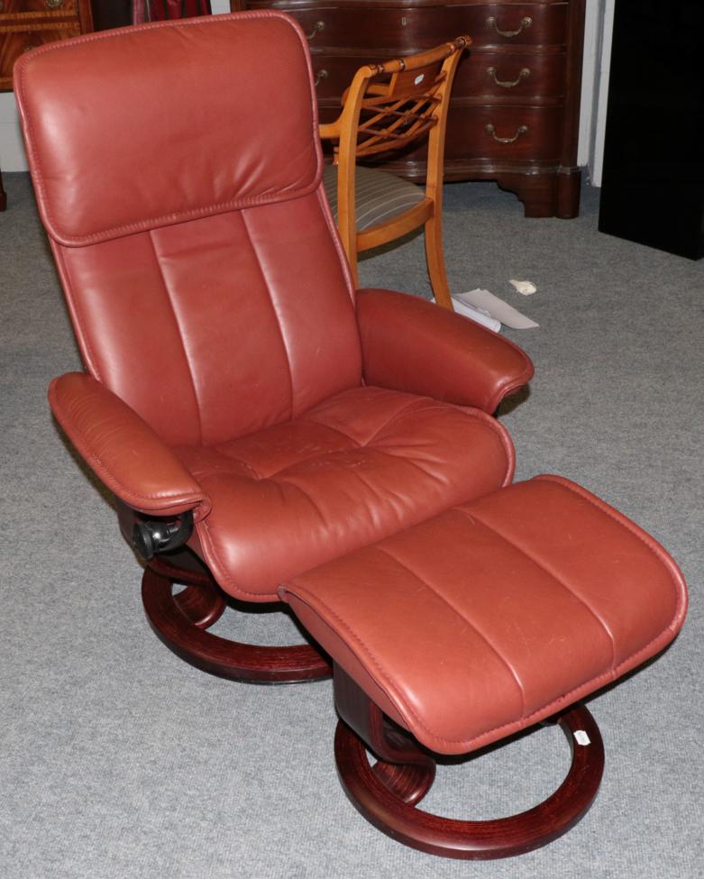 An Ekornes Stressless Swivel Armchair, modern, the stained beech frame with padded back support