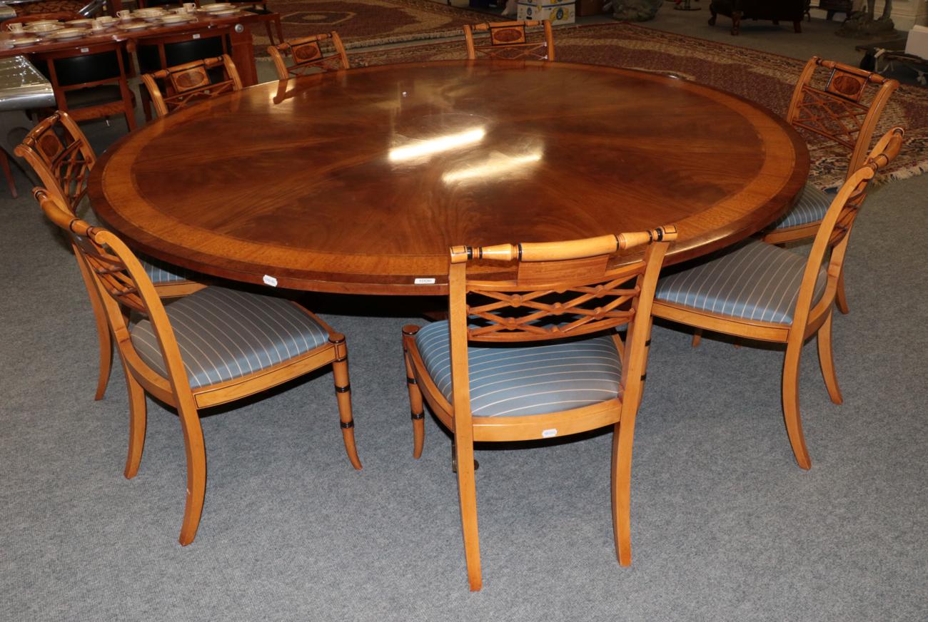 A Reproduction Mahogany Satinwood and Burr Wood Crossbanded Circular Dining Table, in the Regency