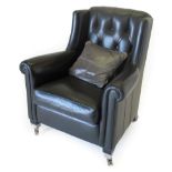 Duresta: A Black Leather Button-Back Armchair, modern, with rounded arms and squab cushion, on ebony