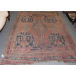 Ushak carpet, the soft brick red field with central floral head medallion enclosed by multiple
