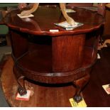 A 1920/30s round two-tier table on ball and claw feet