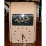 A 1930s pink bakelite cased Vitascope clock with ship automata