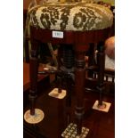 ^ A Regency mahogany adjustable piano stool on turned legs, minimum height 50cm