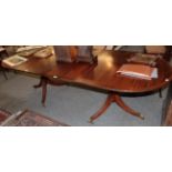 A 20th century mahogany twin pedestal D end dining table, with one additional leaf. 74cm by 99cm