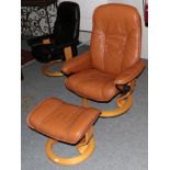An Ekornes Stressless Swivel Lounge Chair, in tan leather, with padded arms and beech frame, 77cm by