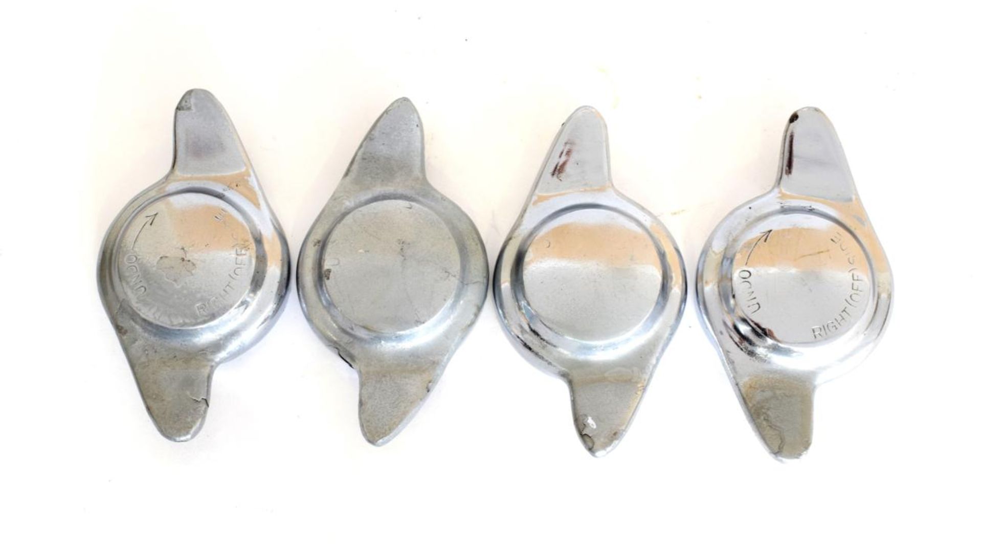 Four Chrome on Brass Wheel Spinners, in need of rechroming, partly covered in grey spray paint
