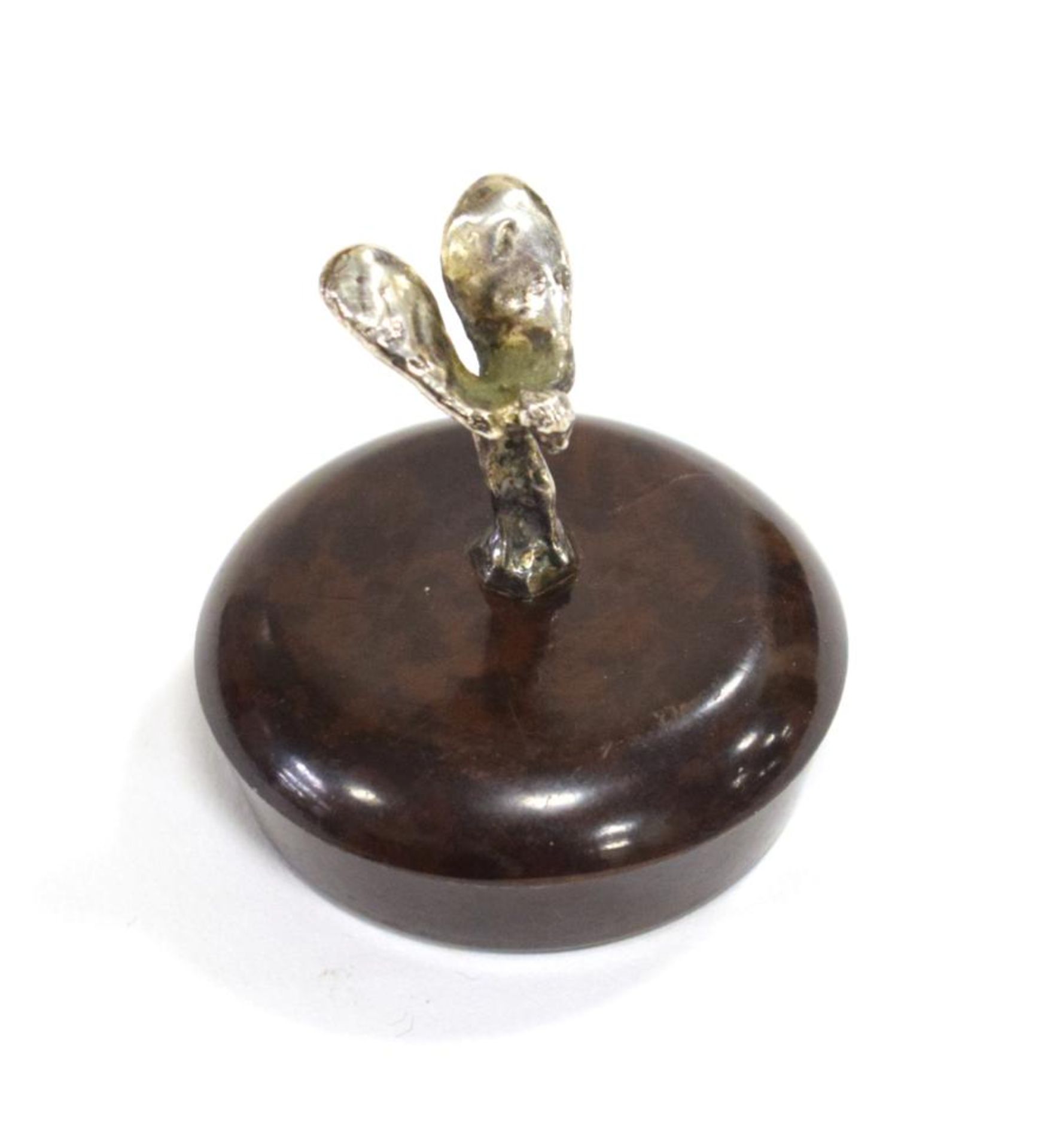 A Miniature Rolls-Royce Spirit of Ecstasy Chromed Car Mascot, mounted on a brown bakelite cap, 3cm