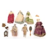 19th Century Dolls House Dolls, comprising a small bisque doll with moulded hair and painted face,