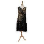 Circa 1920's Black Cotton Sleeveless Evening Dress, decorated with a large gold sequin 'flower