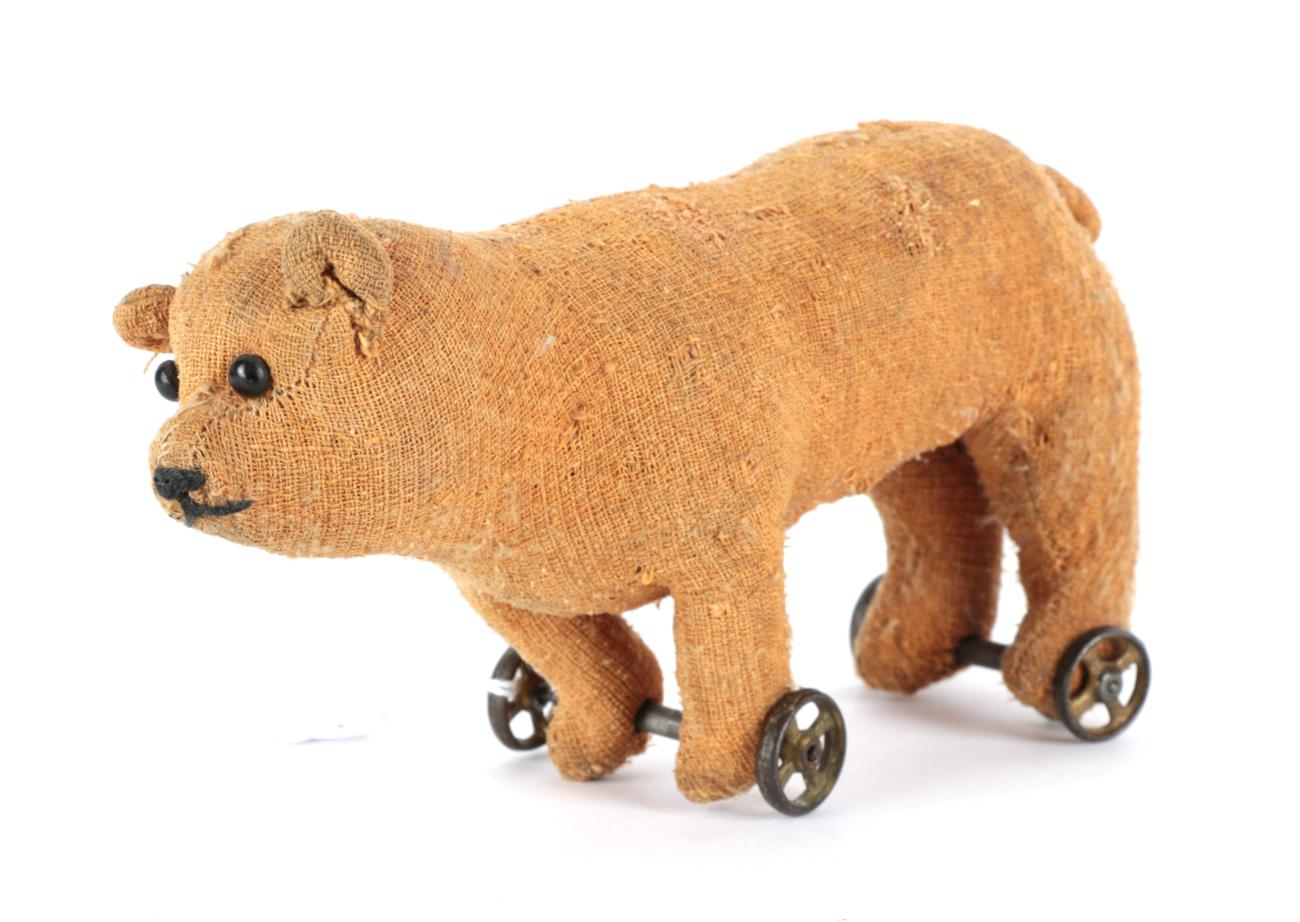 Early 20th Century Miniature Bear on Wheels, with boot button eyes, in brown worn plush, stitched