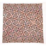 Circa 1870 American Pin Wheel Pattern Quilted Coverlet, incorporating squares of brown and floral