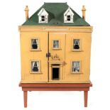 Circa 1900 Dolls House, built over three storeys with a cream painted facade, green painted hinged