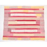 Late 19th/Early 20th Century Decorative Strippy Quilt, incorporating coloured fabrics in red, pink