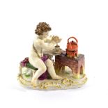 A Meissen Porcelain Figure of a Cherub, late 19th century, sitting at a table beside a brazier