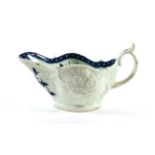 A Worcester Porcelain Sauceboat, circa 1765, painted in underglaze blue with The Sauceboat Peony