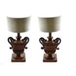 A Pair of Italian Pine Lamp Bases, 18th century and later, as fluted twin-handled urn shaped vases