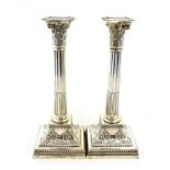 A Pair of Victorian Silver Candlesticks, by James Dixon and Son, Sheffield, 1900, the square bases