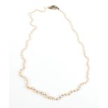 A Pearl Necklace, graduated pearls knotted to an emerald and diamond snap, length 44.7cm (a.f.). The