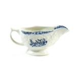 A Lowestoft Porcelain Sauceboat, circa 1775, printed in underglaze blue with flower sprays within