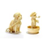 An Austrian Ivory Figure of a Dog, circa 1900, seated wearing a smoking cap, smoking a pipe, 4.5cm