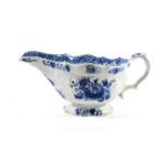 A Bow Porcelain Sauce Boat, circa 1765, painted in underglaze blue with flower sprays and sprigs