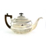 A George III Silver Teapot, by William Bennett, London, 1807, shaped part-fluted oblong, with wood