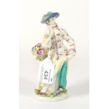 A Bow Porcelain Figure of a Lady, circa 1760, standing wearing a turquoise hat, a basket of