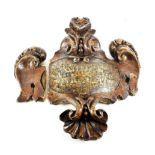 A Carved, Painted and Gilt Pine Rococo Cartouche, mid 18th century, with central oval panel
