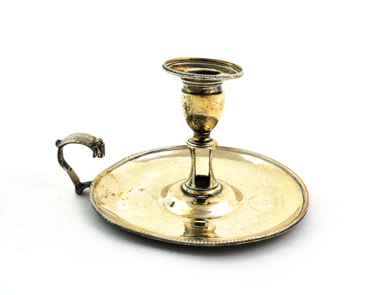 A George III Silver Chamber-Candlestick, by Robert Hennell, London, 1784, circular and with beaded