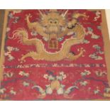 A Chinese Silkwork Banner, worked in coloured threads with a dragon amongst cloud scrolls holding