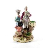 A Meissen Figural Group, 19th century, modelled as a gallant and his beau, on rocky naturalistic