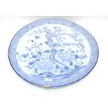 An Arita Porcelain Dish, Meiji period, painted in underglaze blue with a bird amongst flowering