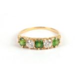 A Demantoid Garnet and Diamond Five Stone Ring, circa 1900, three oval cut garnets alternate with