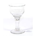 A Sweetmeat or Champagne Glass, circa 1750, the ogee bowl on a fluted baluster stem and circular