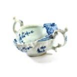 A Worcester Porcelain Two-Handled Sauce Boat, circa 1755, painted in underglaze blue with The Two-