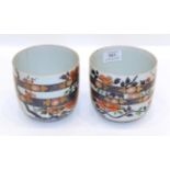 A Pair of Imari Porcelain Pots, Edo period, painted with flowers and rockwork and with blue
