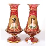 A Pair of Bohemian Ruby Glass Vases, circa 1900, decorated with bust portraits of young ladies in