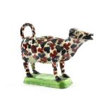 A Swansea Creamware Cow Creamer and Cover, circa 1820, naturalistically modelled with black and