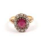 A Red Stone and Diamond Cluster Ring, the oval cut red stone within a border of old cut diamonds, to