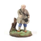 A Gardner Porcelain Figure of a Beggar, mid 19th century, wearing traditional costume standing on