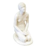 A White Marble Figure of a Young Girl, kneeling on an oval plinth, 48cm high